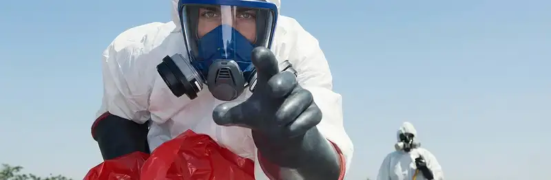 sewage clean up technician wearing protective gear handling biohazard materials in Fort Collins, CO